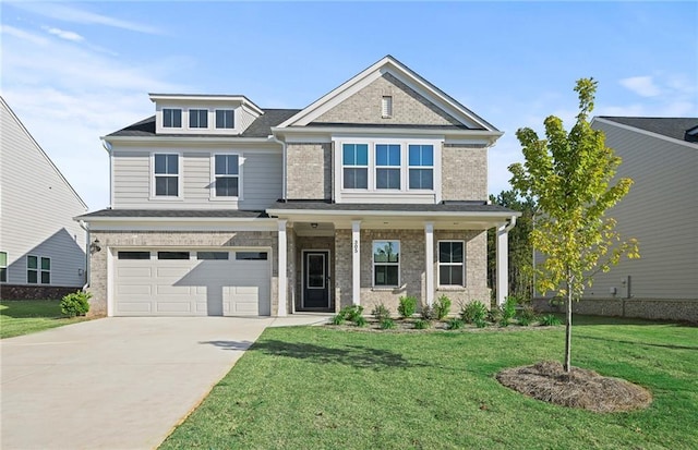 view of front of house featuring a front lawn, a garage, and a porch