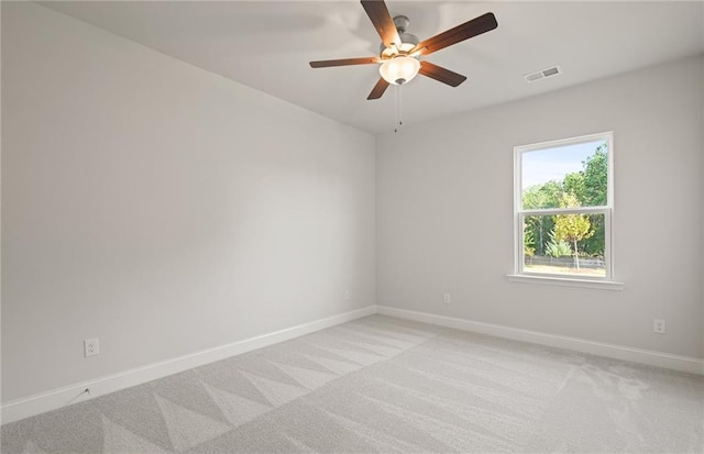 carpeted spare room featuring ceiling fan