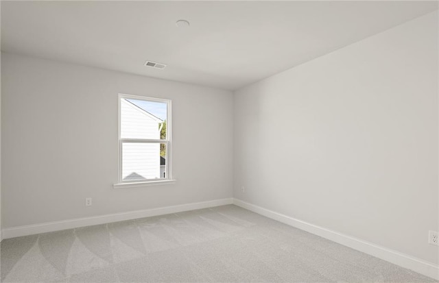 spare room with light colored carpet