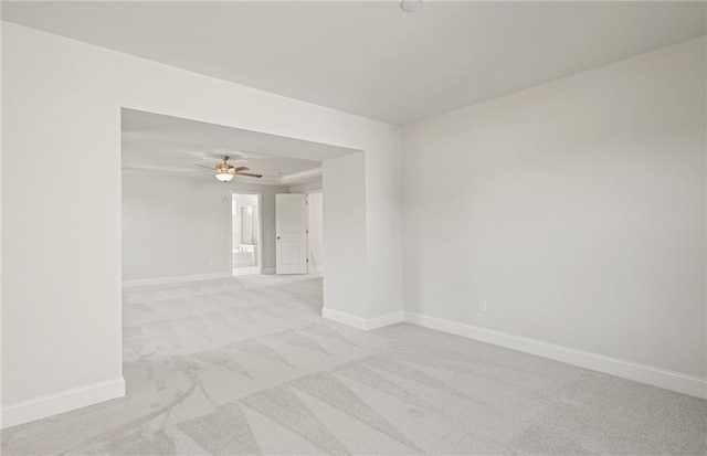 unfurnished room with light carpet and ceiling fan