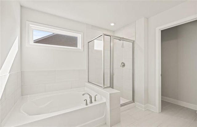 bathroom featuring separate shower and tub