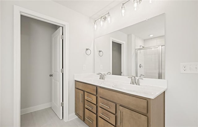 bathroom with tile patterned flooring, walk in shower, and vanity