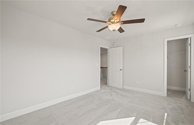 unfurnished bedroom with light carpet, ceiling fan, and a closet