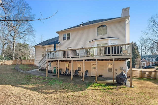 back of property featuring a patio, a yard, and a deck