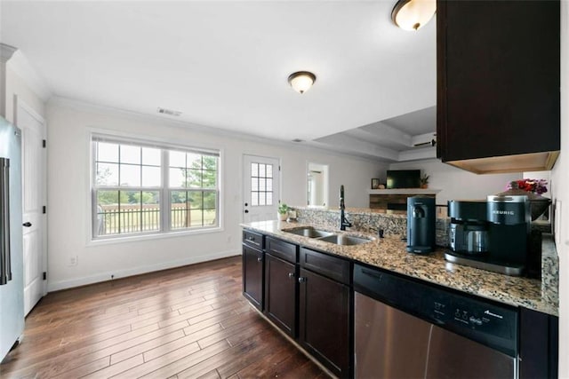 kitchen with stainless steel dishwasher, sink, light stone counters, and dark hardwood / wood-style flooring