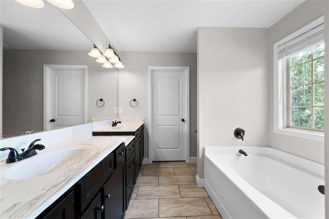 bathroom with vanity and a tub to relax in