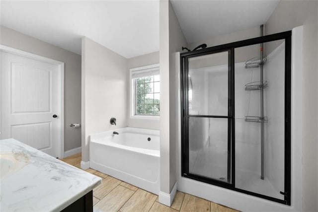 bathroom with vanity, shower with separate bathtub, and hardwood / wood-style flooring