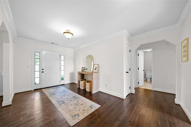 foyer with ornamental molding and dark wood-type flooring