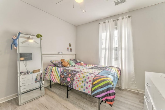 bedroom with ceiling fan and light hardwood / wood-style floors