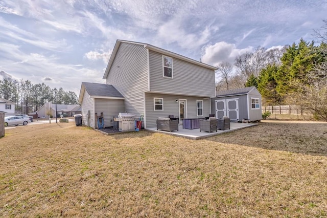 rear view of property with a storage shed, a yard, an outdoor living space, and a patio