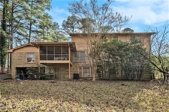 back of property featuring a sunroom and central AC unit