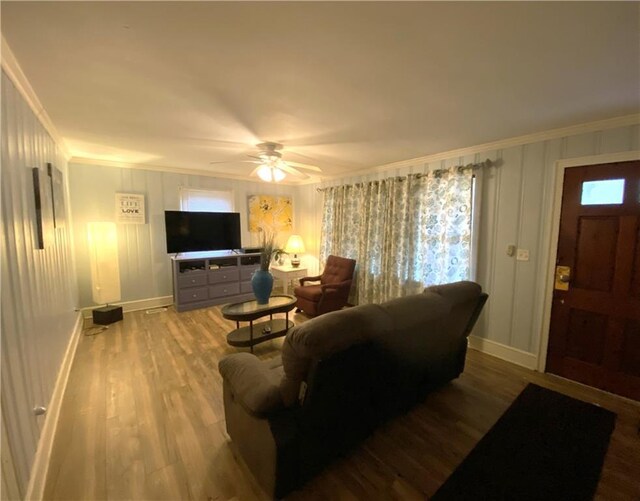 living room with ceiling fan, ornamental molding, wood-type flooring, and a wealth of natural light