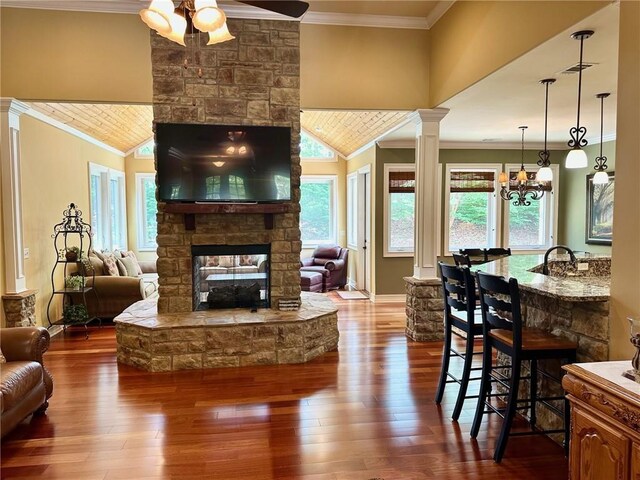 3397 Holly Glen Dr, Dacula, GA 30019 - living area featuring dark wood-style floors, ornamental molding, a ceiling fan, and a fireplace
