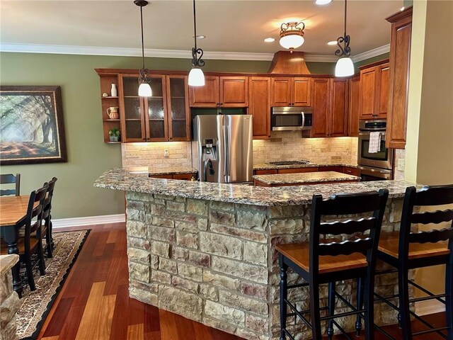 3397 Holly Glen Dr, Dacula, GA 30019 - kitchen featuring light stone counters, a kitchen breakfast bar, appliances with stainless steel finishes, and baseboards