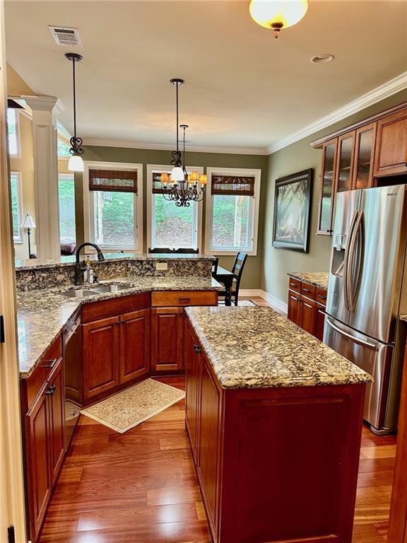 3397 Holly Glen Dr, Dacula, GA 30019 - kitchen with appliances with stainless steel finishes, crown molding, dark wood finished floors, and a sink
