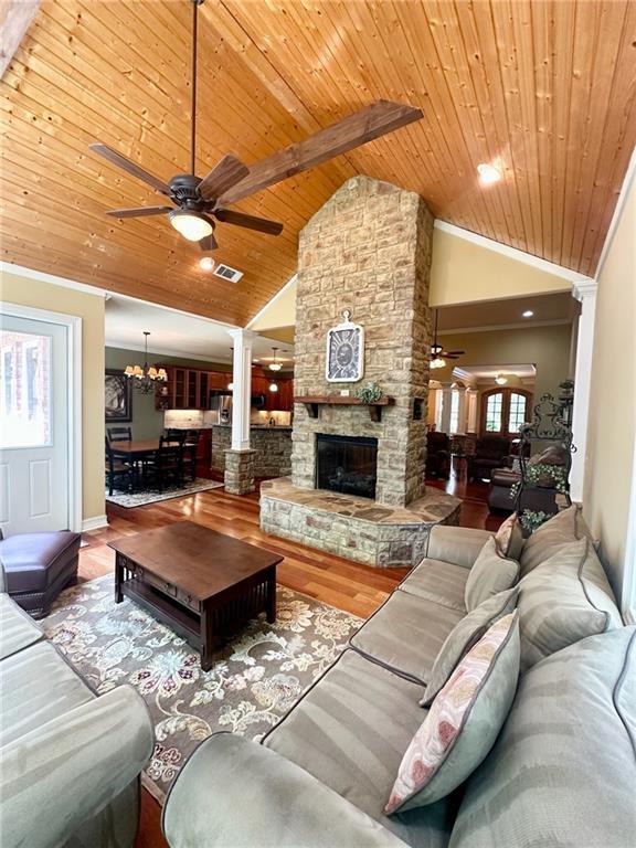 3397 Holly Glen Dr, Dacula, GA 30019 - living area with visible vents, wood finished floors, ceiling fan with notable chandelier, and wood ceiling