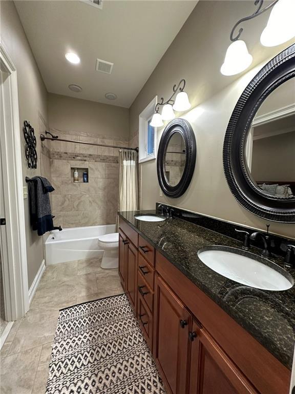 3397 Holly Glen Dr, Dacula, GA 30019 - full bath with toilet, shower / bath combo, a sink, and visible vents