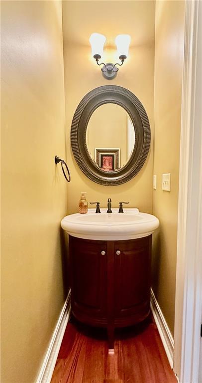 3397 Holly Glen Dr, Dacula, GA 30019 - bathroom with a sink, wood finished floors, and baseboards