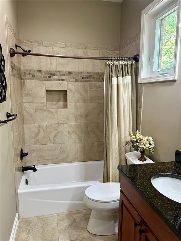 3397 Holly Glen Dr, Dacula, GA 30019 - full bath featuring shower / bath combo with shower curtain, toilet, tile patterned flooring, and vanity