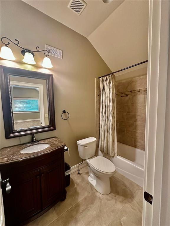 3397 Holly Glen Dr, Dacula, GA 30019 - bathroom featuring visible vents, toilet, tile patterned flooring, and vaulted ceiling