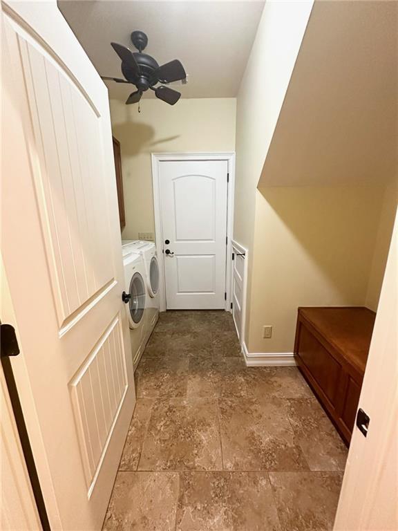3397 Holly Glen Dr, Dacula, GA 30019 - laundry room featuring washing machine and clothes dryer, ceiling fan, laundry area, stone finish floor, and baseboards