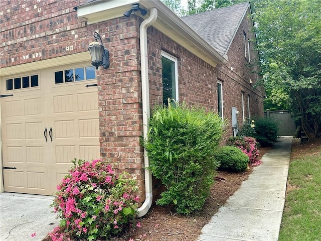 3397 Holly Glen Dr, Dacula, GA 30019 - view of property exterior with a garage, brick siding, and roof with shingles