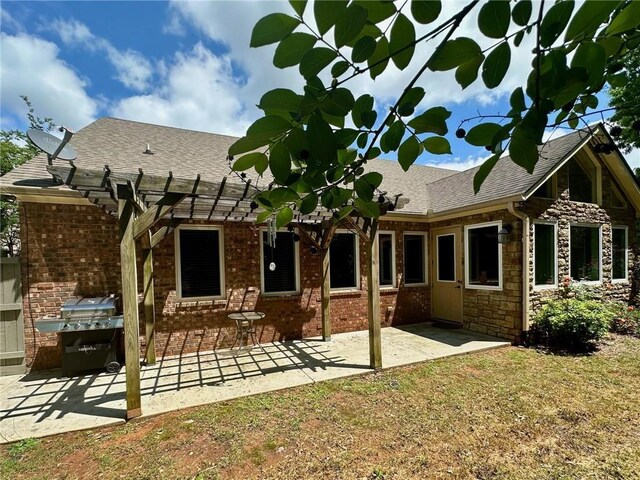 3397 Holly Glen Dr, Dacula, GA 30019 - back of house featuring brick siding, roof with shingles, a patio area, and a pergola
