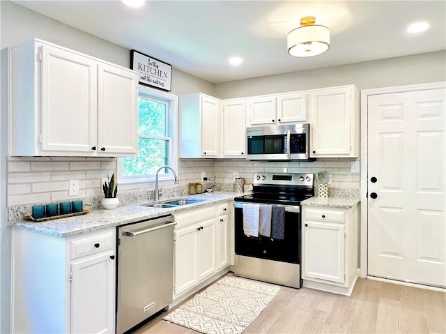 430 Thornbush Trce, Lawrenceville, GA 30046 - kitchen with stainless steel appliances, white cabinetry, backsplash, and recessed lighting