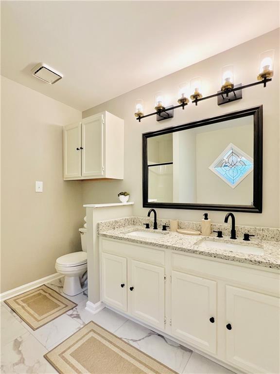 430 Thornbush Trce, Lawrenceville, GA 30046 - bathroom with double vanity and marble look tile flooring