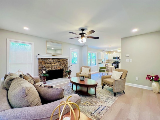 430 Thornbush Trce, Lawrenceville, GA 30046 - living area featuring light wood finished floors, ceiling fan, recessed lighting, and a fireplace