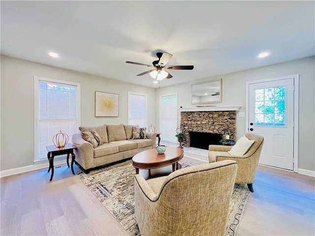 430 Thornbush Trce, Lawrenceville, GA 30046 - living area featuring ceiling fan, light wood-type flooring, a stone fireplace, and recessed lighting