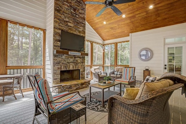 sunroom / solarium featuring a fireplace, wooden ceiling, ceiling fan, and lofted ceiling