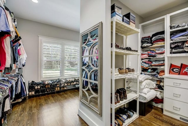 spacious closet with dark wood-type flooring