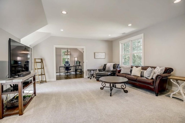 carpeted living room featuring vaulted ceiling