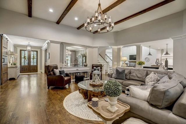 living room with beamed ceiling, a fireplace, a towering ceiling, and hardwood / wood-style floors