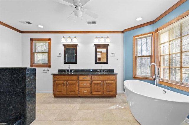 full bathroom with a healthy amount of sunlight, a soaking tub, and visible vents