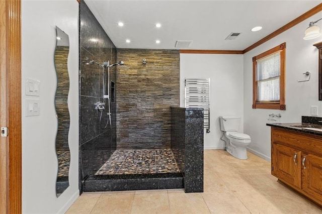 bathroom featuring visible vents, toilet, vanity, baseboards, and walk in shower