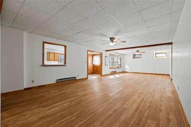 unfurnished living room with light wood-type flooring, baseboards, and baseboard heating