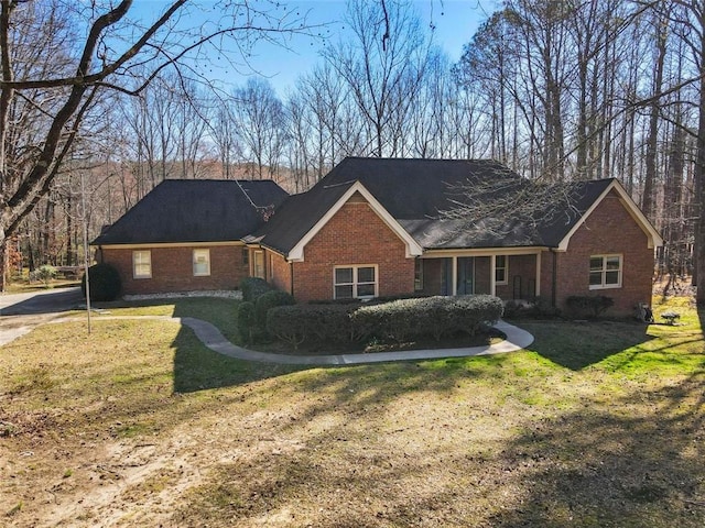 ranch-style house with a front lawn and brick siding