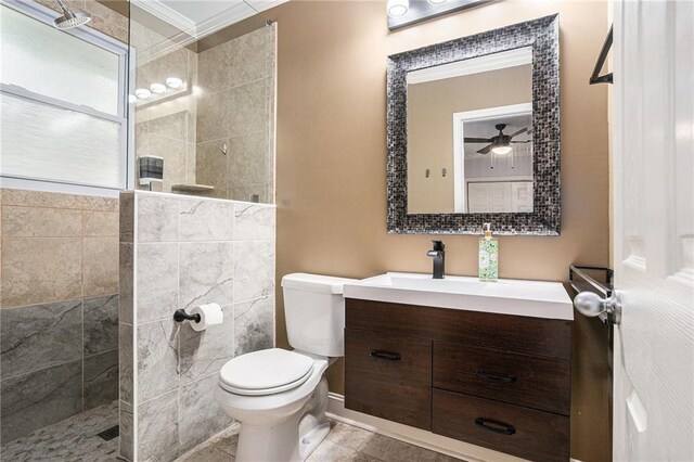 bathroom featuring toilet, a ceiling fan, walk in shower, vanity, and ornamental molding