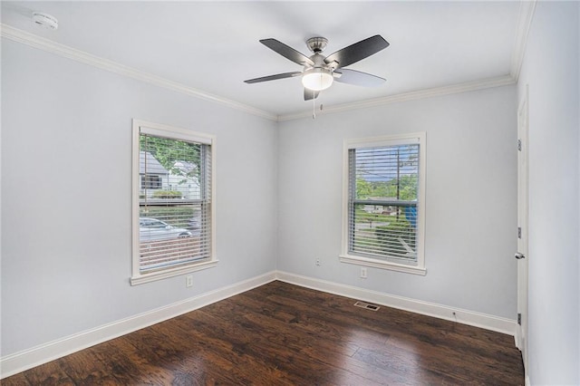 unfurnished room featuring crown molding, plenty of natural light, and dark wood finished floors