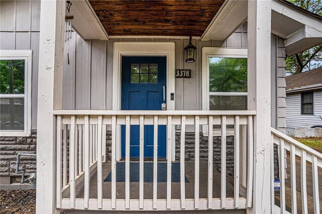 entrance to property featuring board and batten siding and a porch
