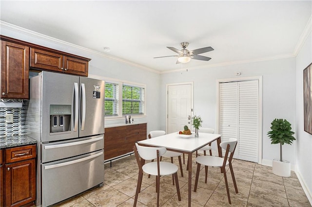 kitchen with light tile patterned flooring, ornamental molding, stainless steel refrigerator with ice dispenser, a ceiling fan, and backsplash