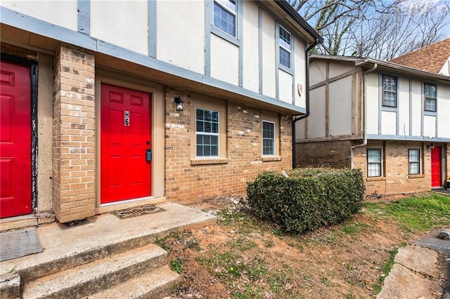 entrance to property featuring brick siding