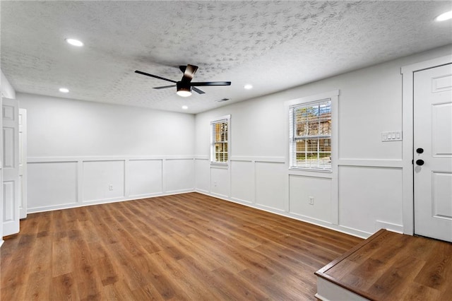 interior space with visible vents, a textured ceiling, wood finished floors, recessed lighting, and ceiling fan