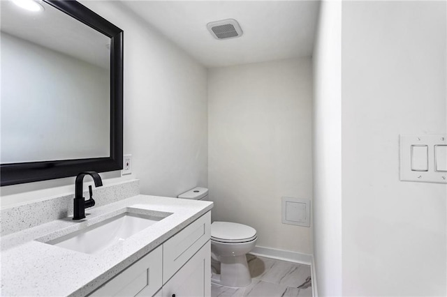 bathroom featuring visible vents, toilet, marble finish floor, baseboards, and vanity