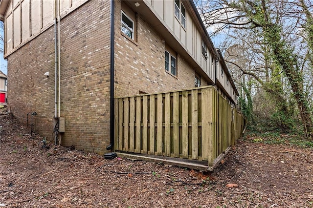 view of home's exterior with brick siding and board and batten siding