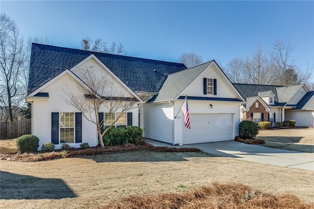 view of front facade featuring a garage, concrete driveway, a front lawn, and roof with shingles