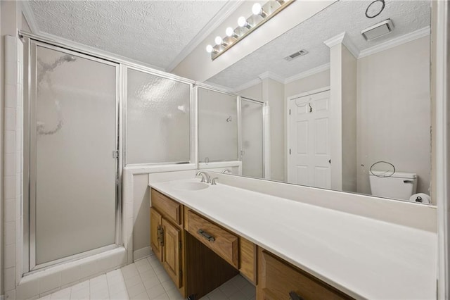 bathroom with tile patterned flooring, a shower with shower door, a textured ceiling, crown molding, and vanity