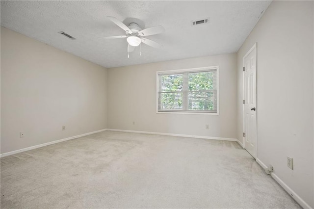 carpeted empty room with a textured ceiling and ceiling fan